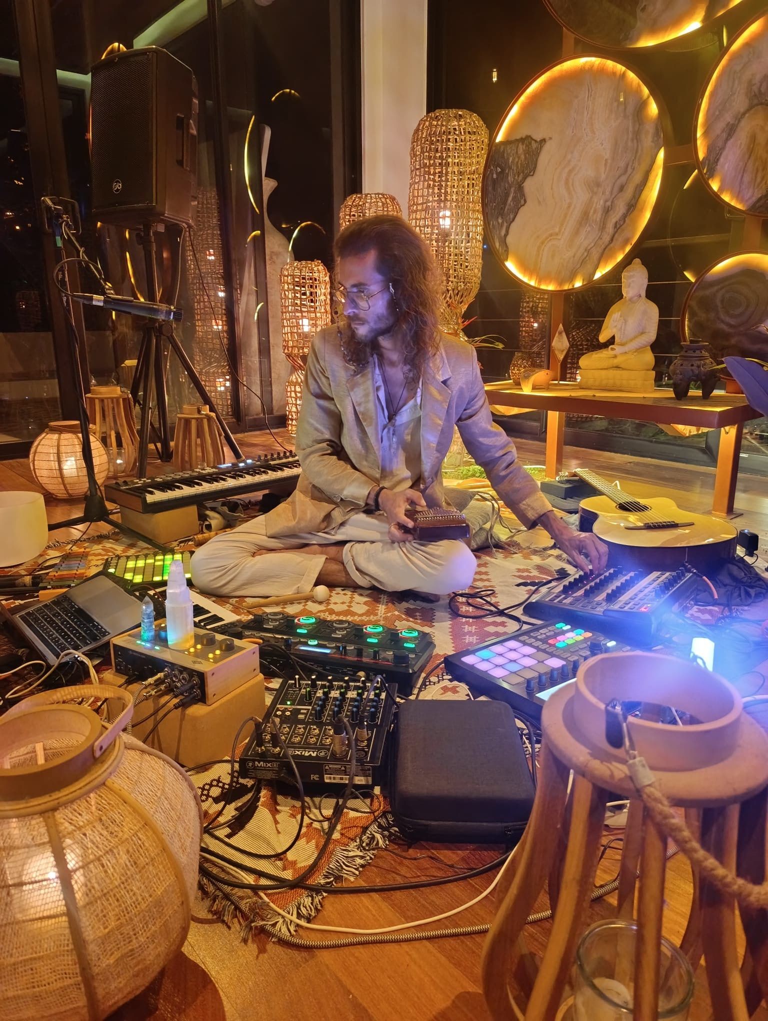 Federico in his studio among synthesizers, gongs and warm lights
